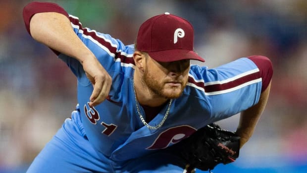 Phillies pitcher Craig Kimbrel looks into the catcher from the mound while pitching in a game.